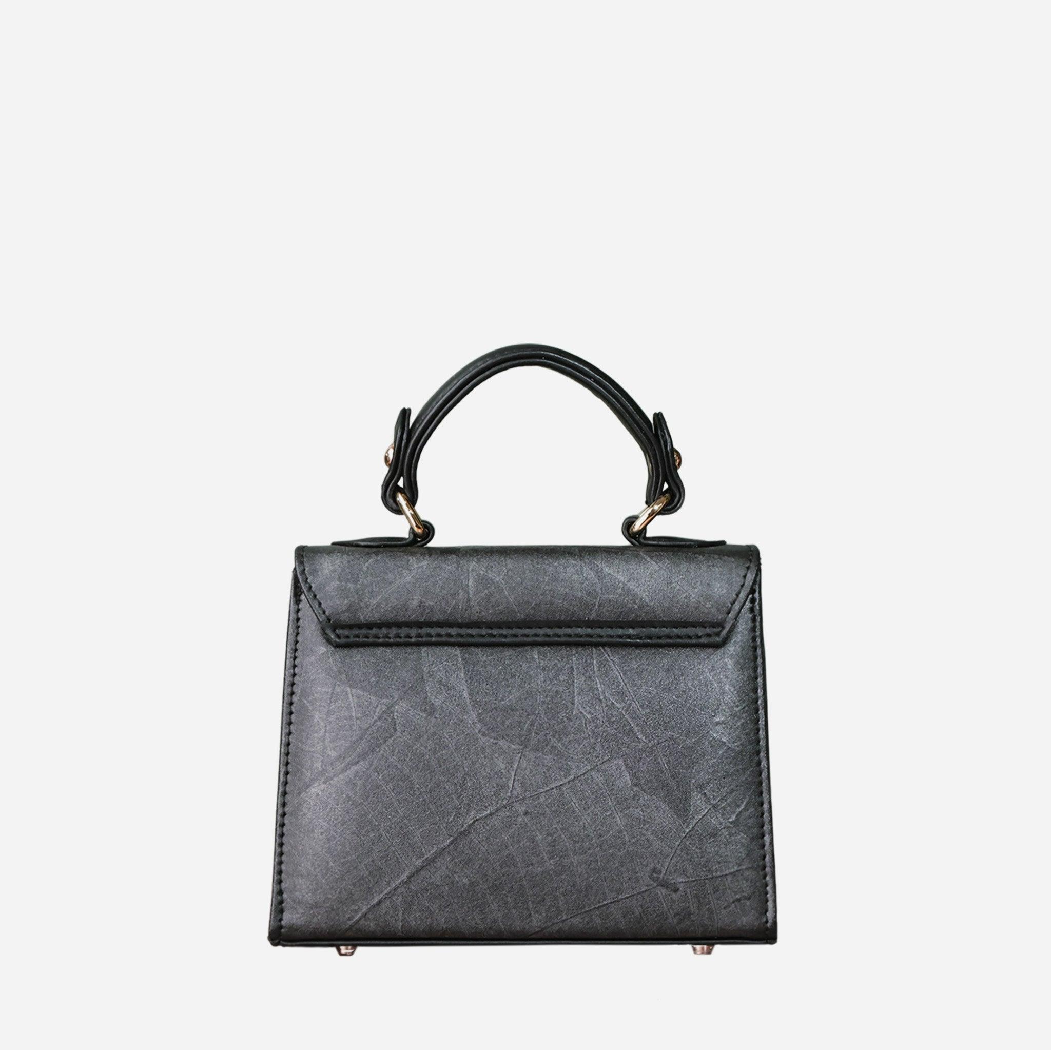 Back view of Kylie Mini Bag in Black Leaf Vegan Leather by Thamon, showcasing its sleek design and sturdy top handle.