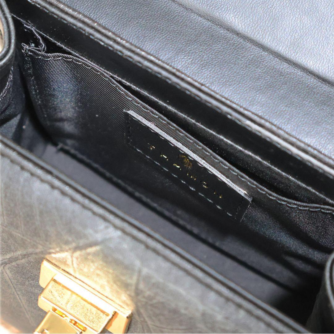 Interior view of Kylie Mini Bag in Black Leaf Vegan Leather by Thamon, highlighting the spacious compartment and open interior pocket.