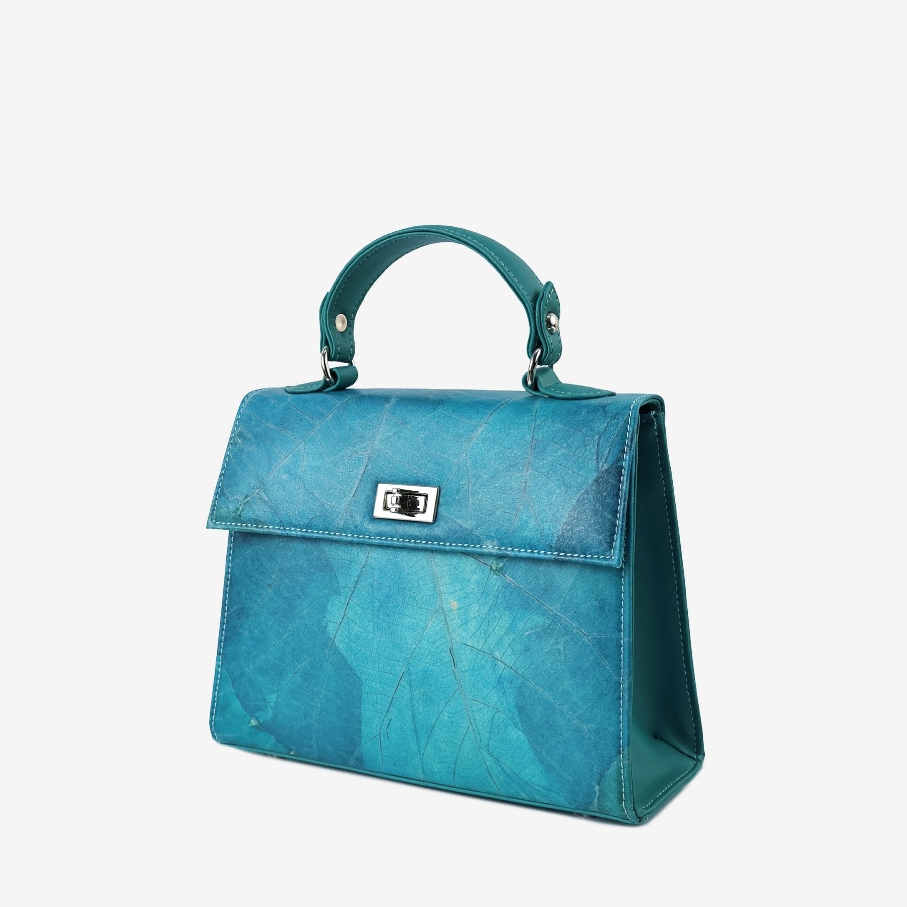 Kylie handbag in turquoise Leaftex with a structured silhouette, top handle, and silver-tone twist-lock closure.