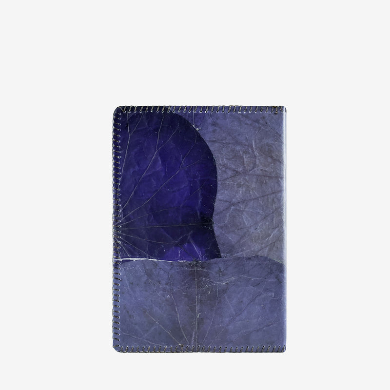 Back view of an indigo blue A5 refillable notebook cover crafted from real lotus leaves. The cover showcases natural leaf veins and a unique textured pattern, with stitched edges that enhance the eco-friendly and handcrafted aesthetic.