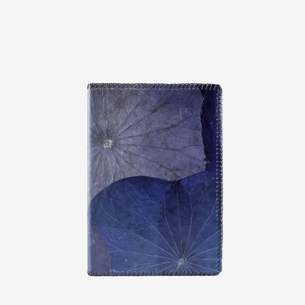 Front view of an indigo blue A5 refillable notebook cover made from real lotus leaves, featuring a unique natural leaf pattern with visible veins and texture. The cover is stitched along the edges, highlighting the eco-friendly design.