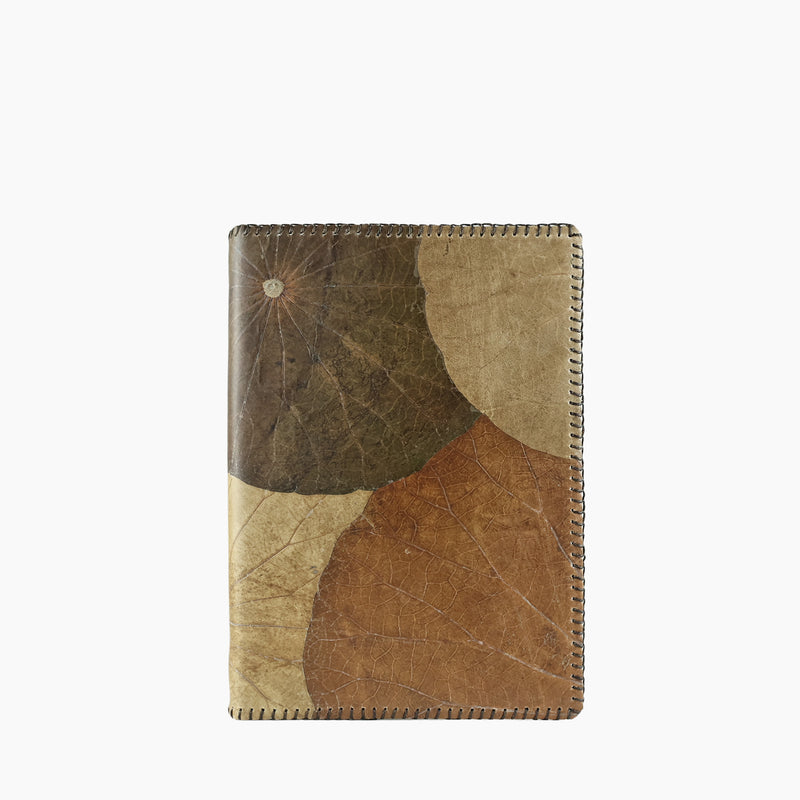 Front view of the Lotus A5 refillable notebook in earthy tones, crafted from sustainable lotus leaf leather with overlapping natural leaf patterns and detailed edge stitching.