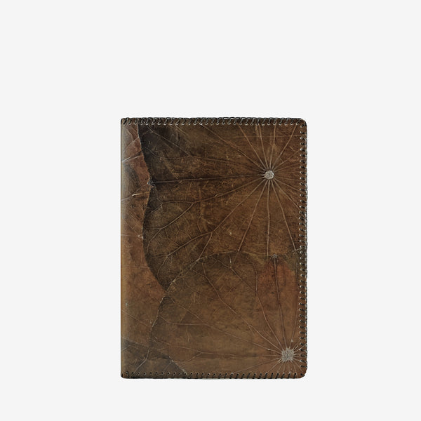 Thamon A5 refillable notebook made from lotus leaves in a weathered umber brown color with natural leaf patterns on the front cover.