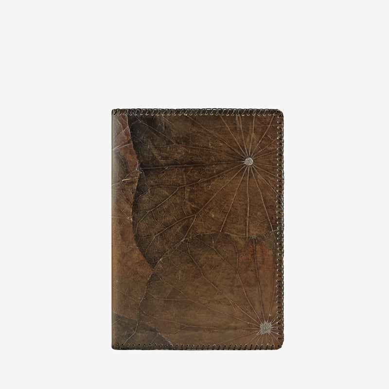 Thamon A5 refillable notebook made from lotus leaves in a weathered umber brown color with natural leaf patterns on the front cover.