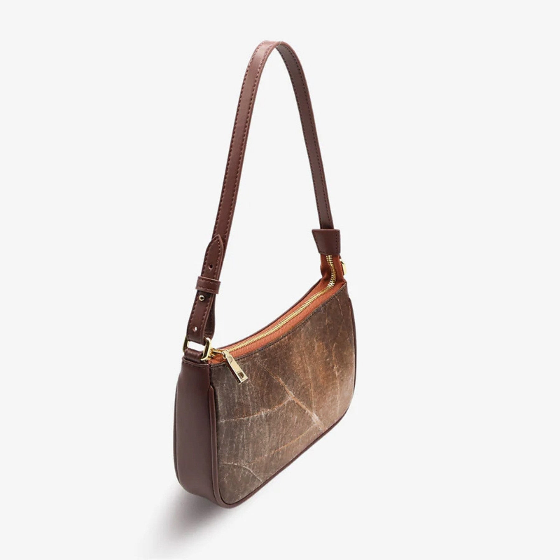 Side profile view of Mila shoulder bag in walnut brown leaf leather highlighting its sleek clean silhouette