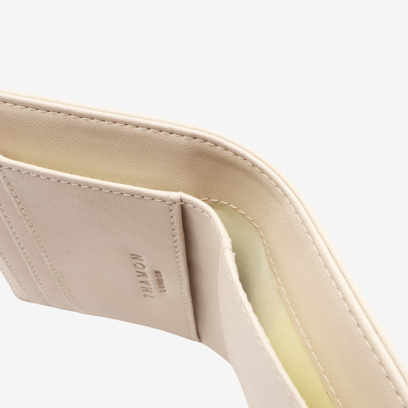 Detailed view of the Milly Compact Wallet in cream by Thamon, focusing on the leaf leather and stitching.