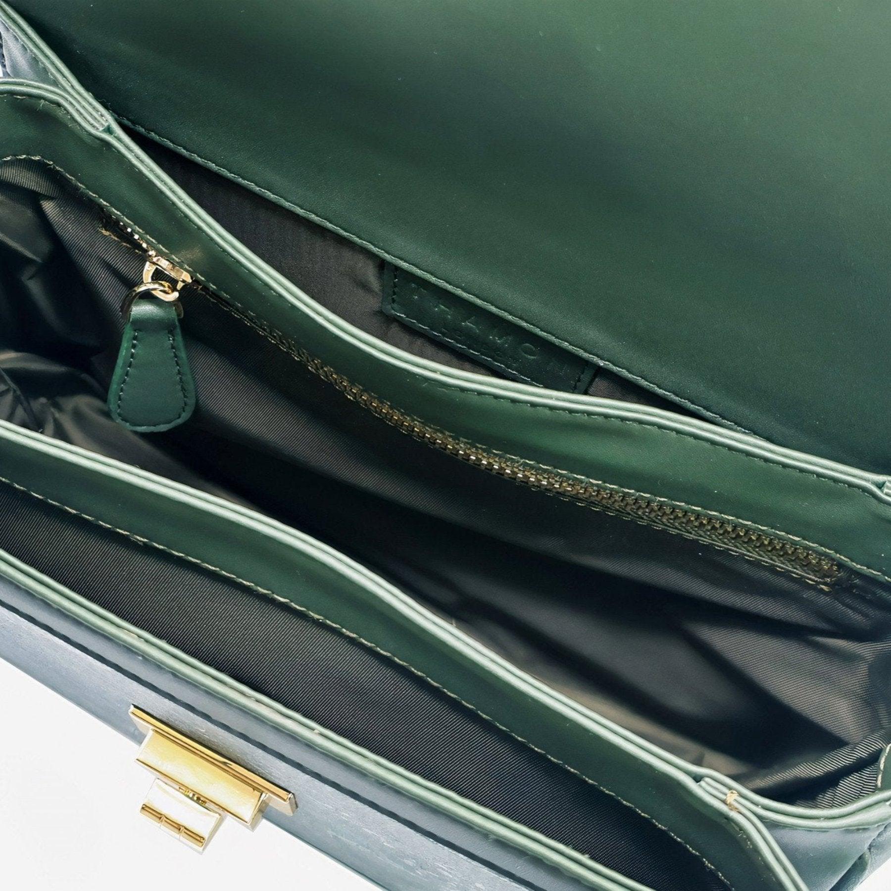 Interior view of the Molly bag in forest green by Thamon, showing multiple compartments and zippered pocket.
