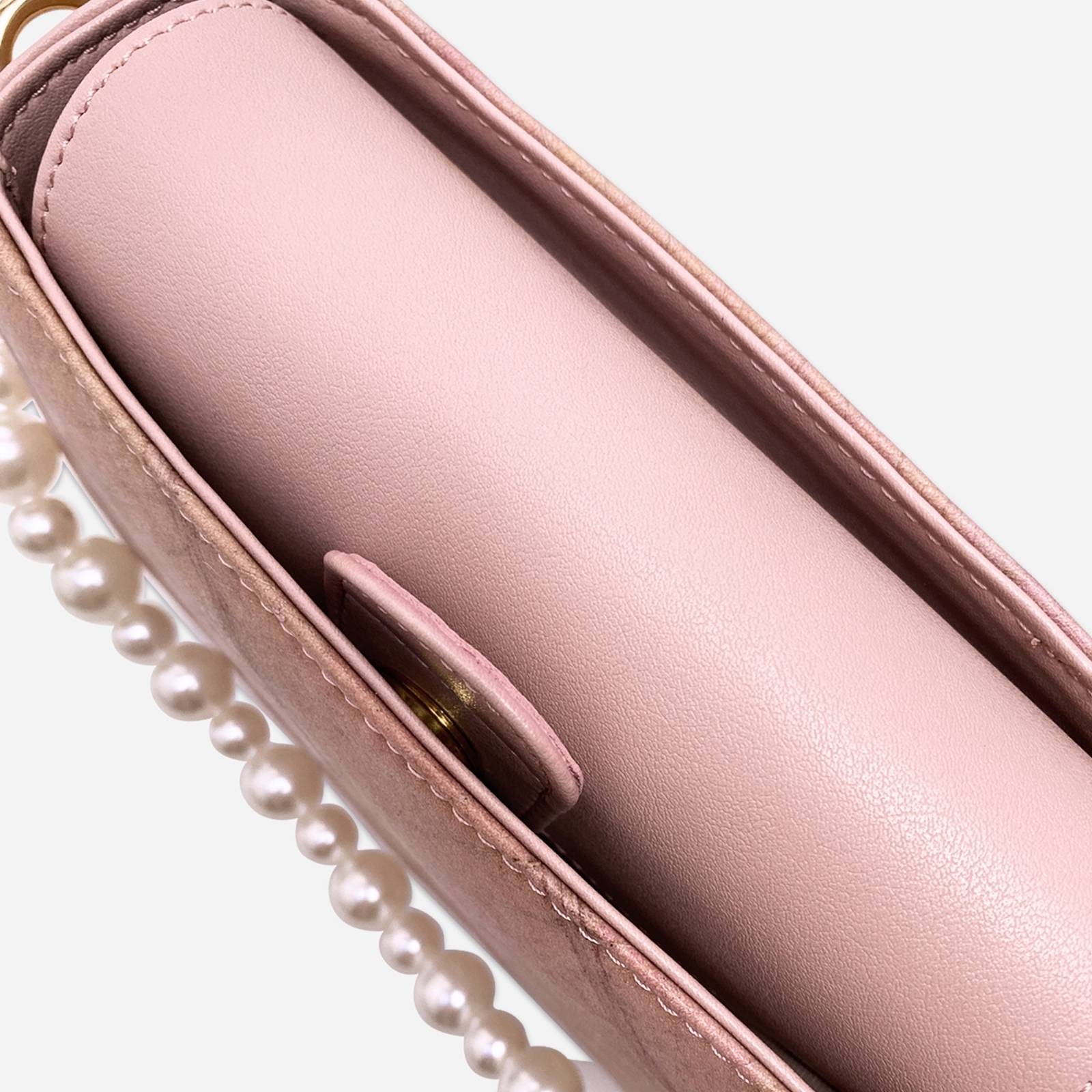 Top interior view of the Pearl Crossbody Bag in Blossom Pink showing the inner compartment and pearl handle