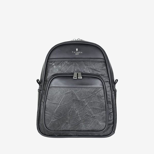 Front view of the Thamon Foglia backpack in black features a sleek, structured design made from sustainable leaf leather. It has a front zip pocket with silver-tone hardware and a textured, natural leaf pattern. The Thamon logo is embossed at the top, blending eco-friendly materials with minimalist style.