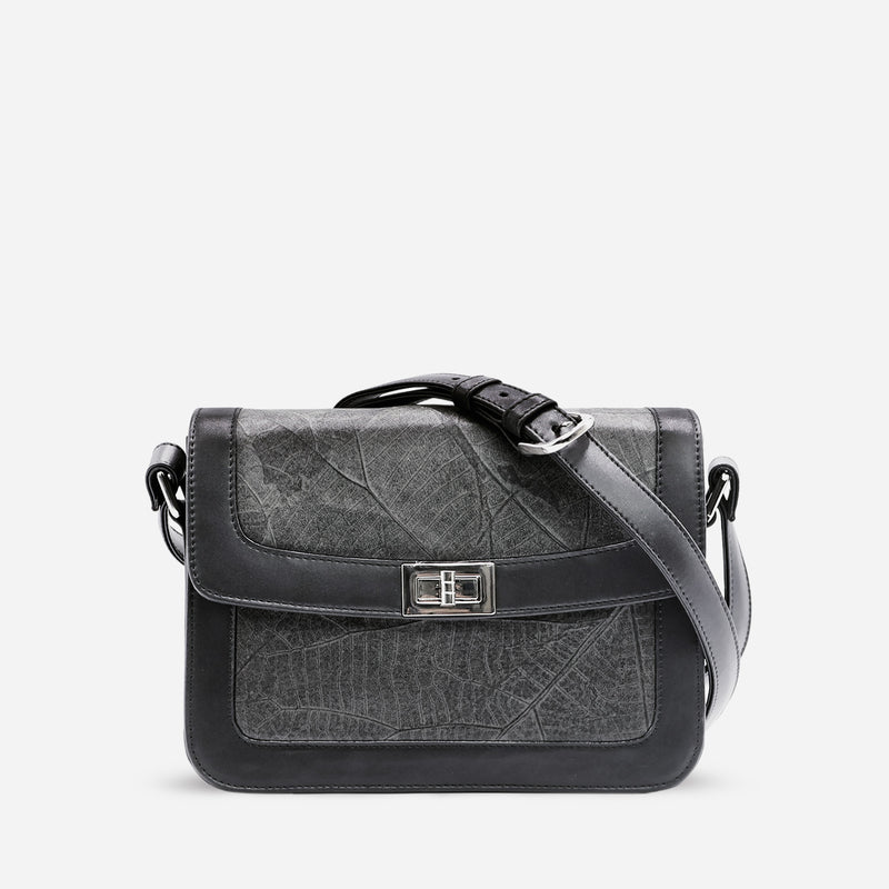 Front view of the Molly Crossbody Bag in Black Vegan Leather by Thamon, showcasing a twist-lock closure and adjustable strap