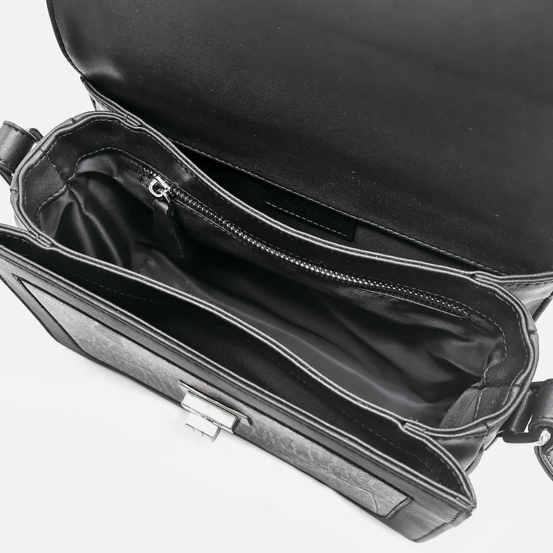 Interior view of the Molly Crossbody Bag in Black by Thamon, highlighting the spacious compartment and inner zip pocket for secure storage.