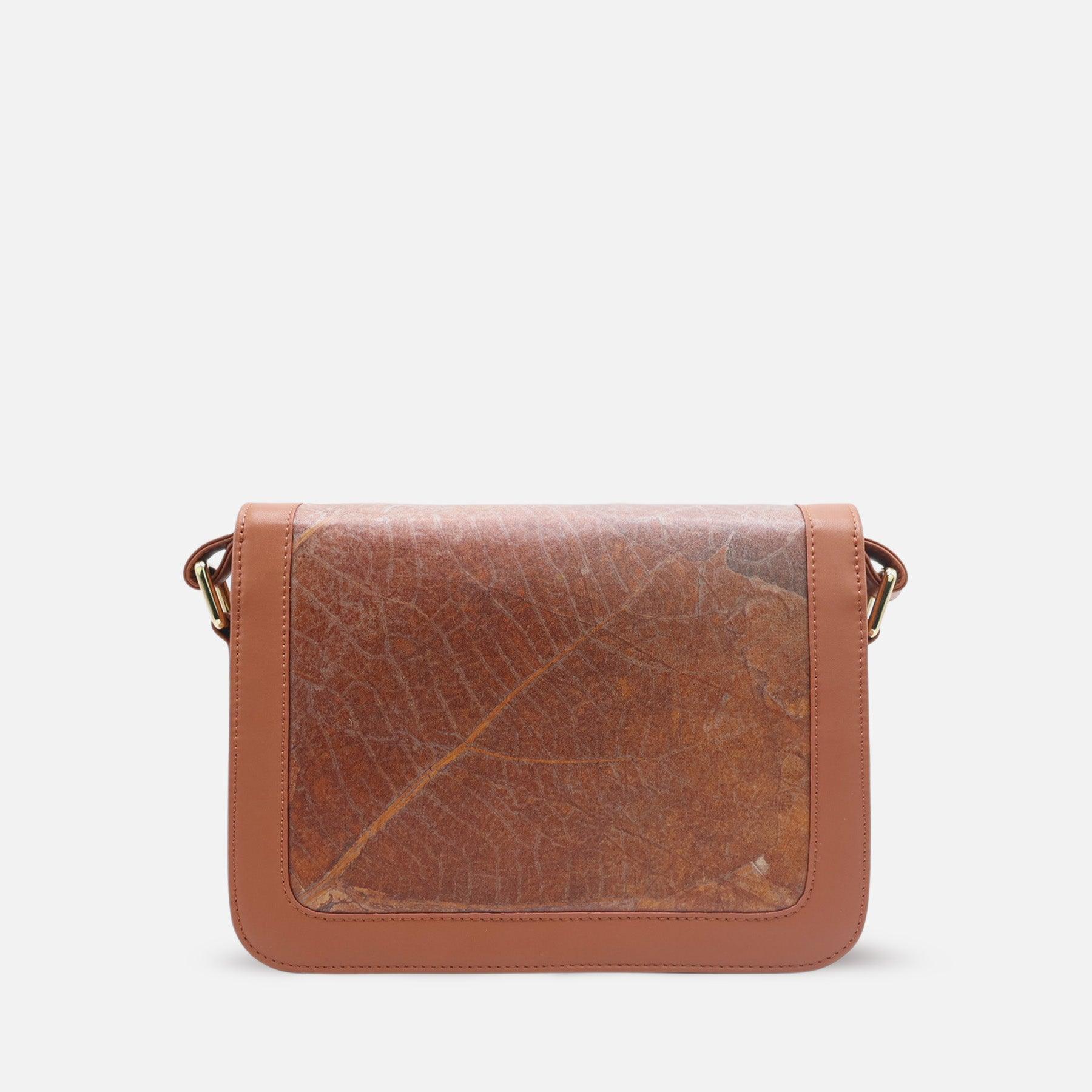 Back view of the Molly bag by Thamon, showcasing the caramel brown vegan leaf leather with a prominent natural leaf pattern. This eco-friendly handbag features a smooth, structured design with subtle stitching along the edges. The sustainable material and minimalist style make it an ideal choice for those who prioritize fashion with a conscience.