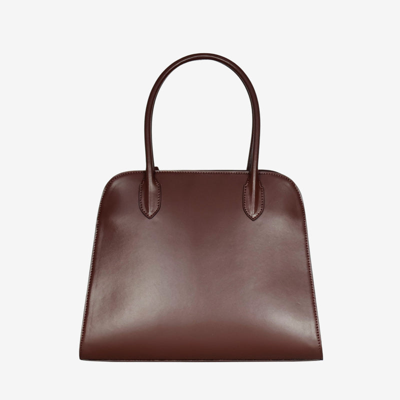 Back view of the Sloane tote bag in spuce brown vegan leather, featuring a smooth, minimalist surface with clean stitching and sturdy top handles