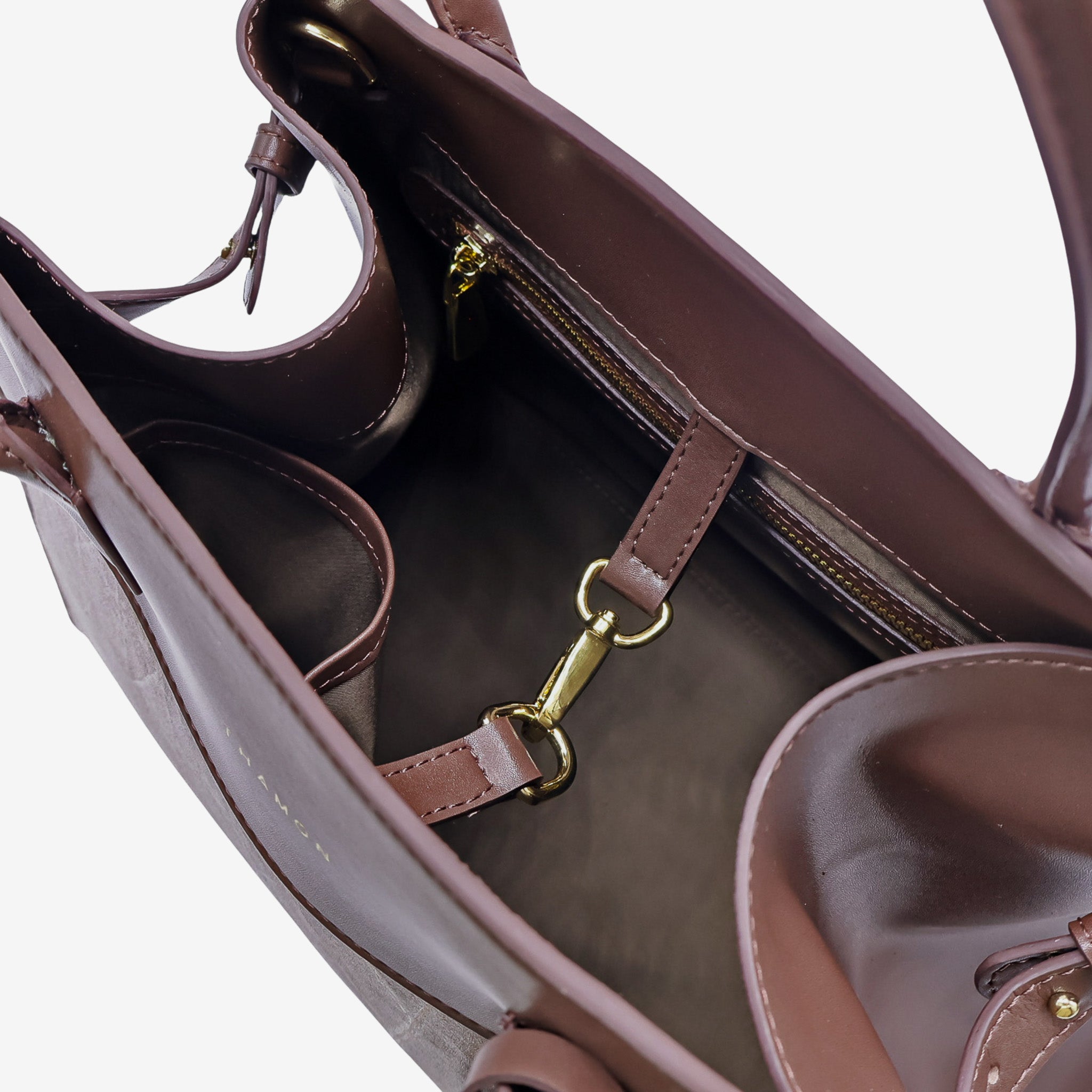 Interior view of the Sloane tote bag in spice brown vegan leather, featuring multiple compartments, a zippered pocket, and gold-tone hardware, including a clasp for added functionality