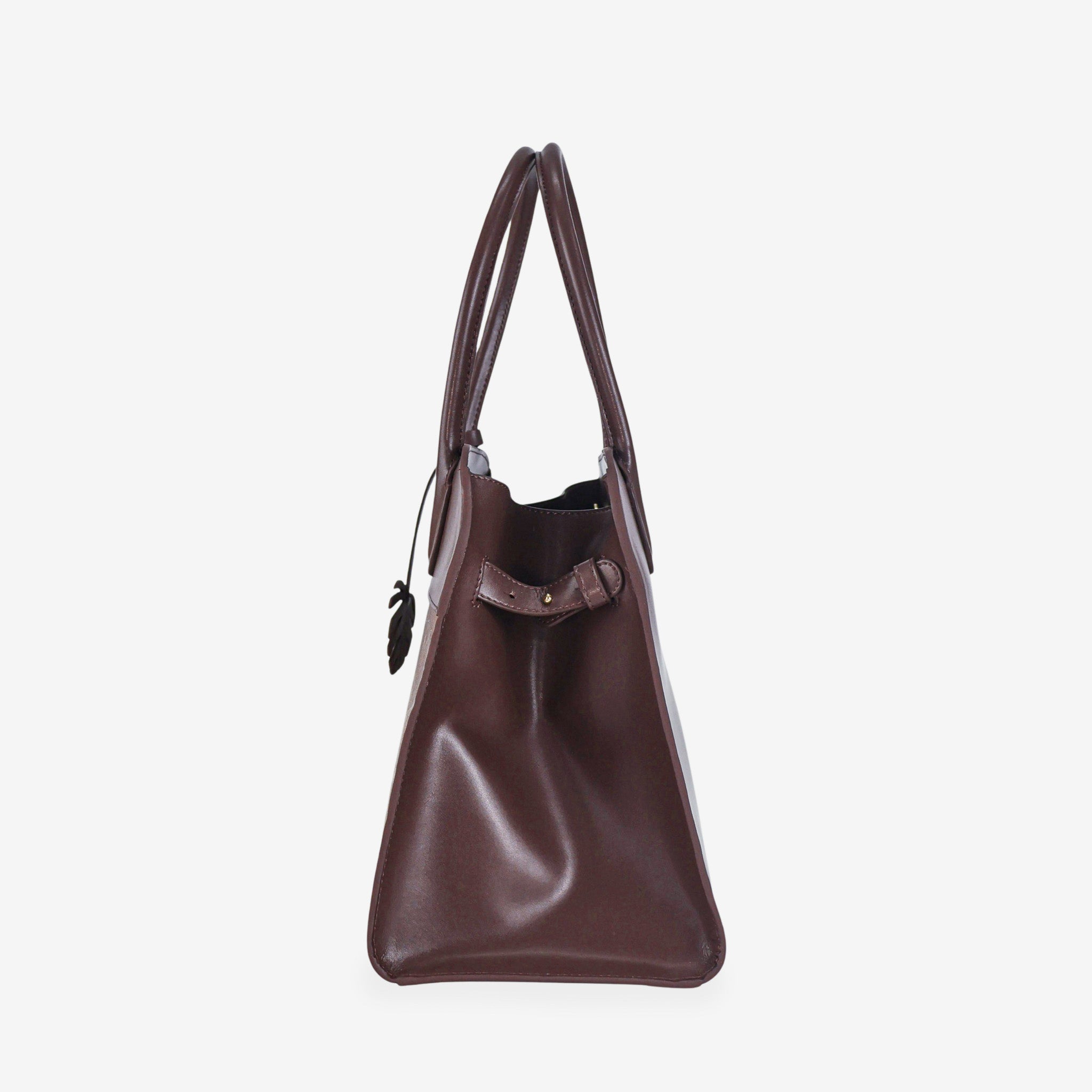 Side profile of the Sloane tote bag in spice brown vegan leather, featuring a smooth, structured surface, sturdy top handles, and a minimal design.