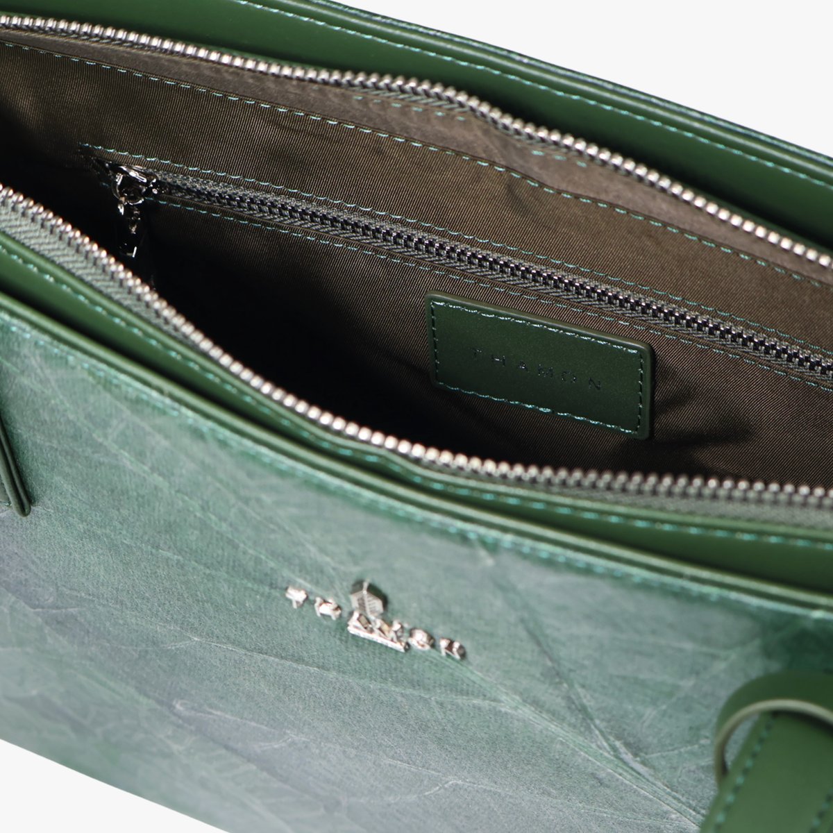 Inside detail view of Thamon London Forest Green tote bag in vegan leaf leather showing interior lining and pocket