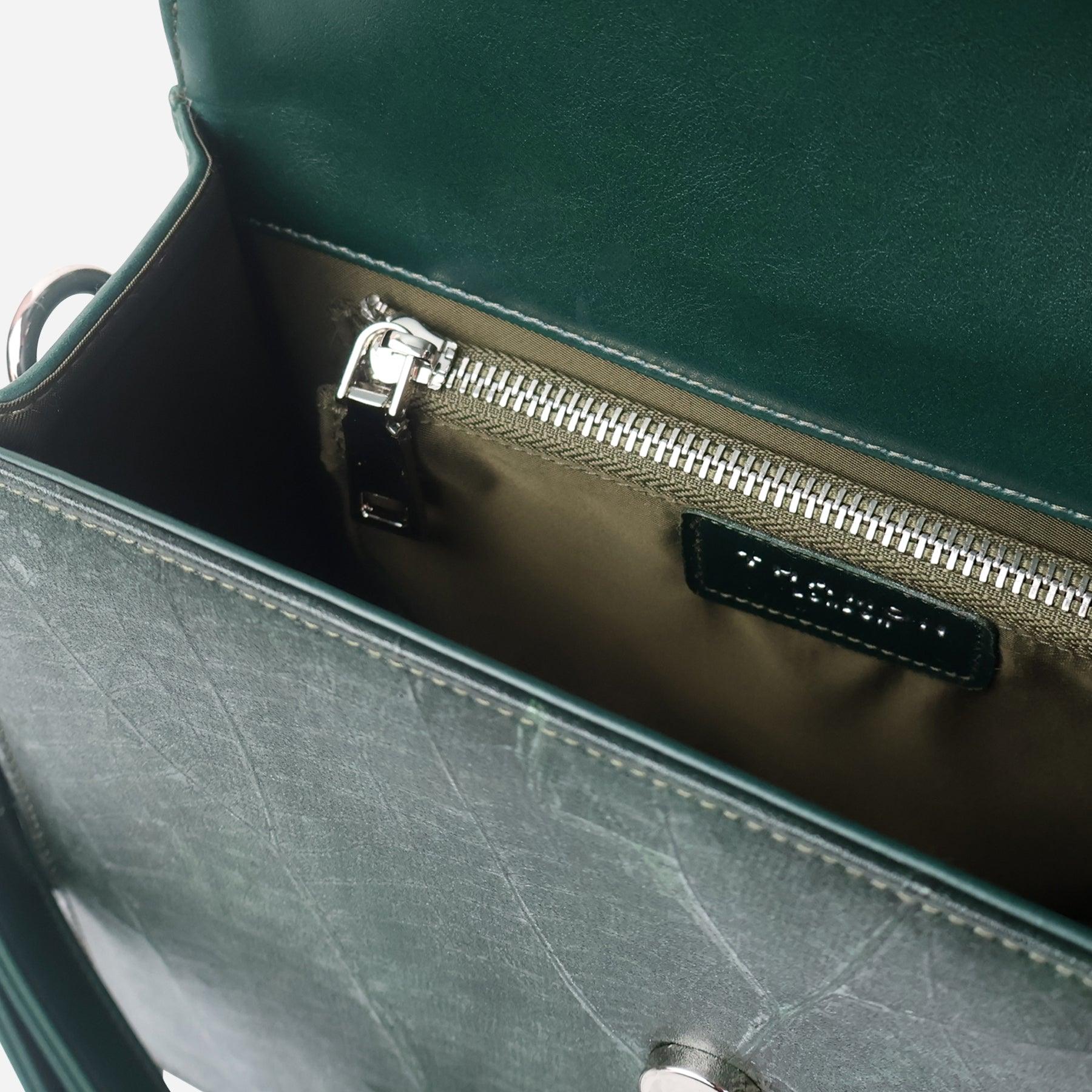 Interior view of Camden crossbody bag in forest green Leaftex, featuring zip pocket and Thamon logo label