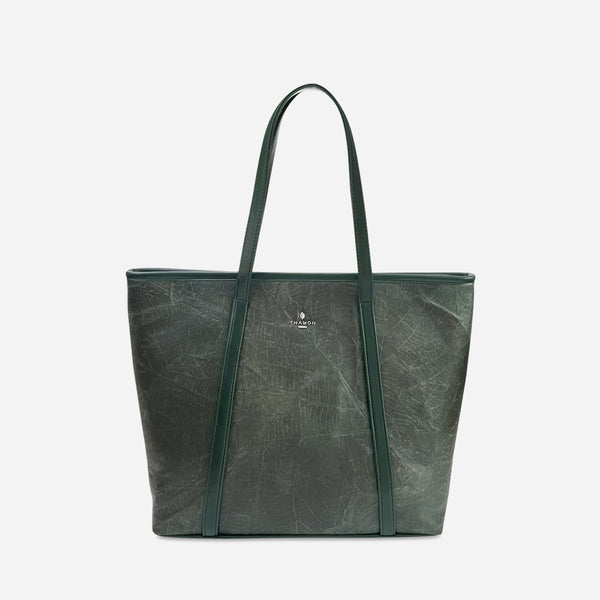 Front view of the Forest green Alma tote bag by Thamon, crafted from sustainable leaf leather, featuring a subtle leaf texture with the Thamon logo silver-plated on the front, dual shoulder straps, and a spacious design for versatile use.