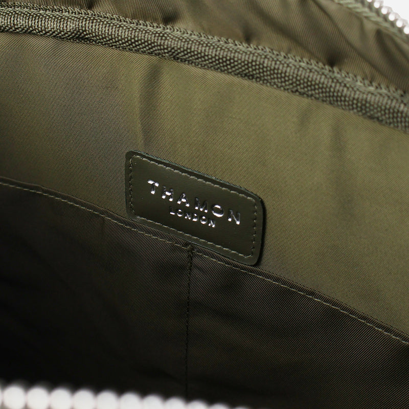 Interior view of a Thamon olive green leaf leather Cambridge briefcase, showing the khaki green lining with the brand's logo and two internal pockets.
