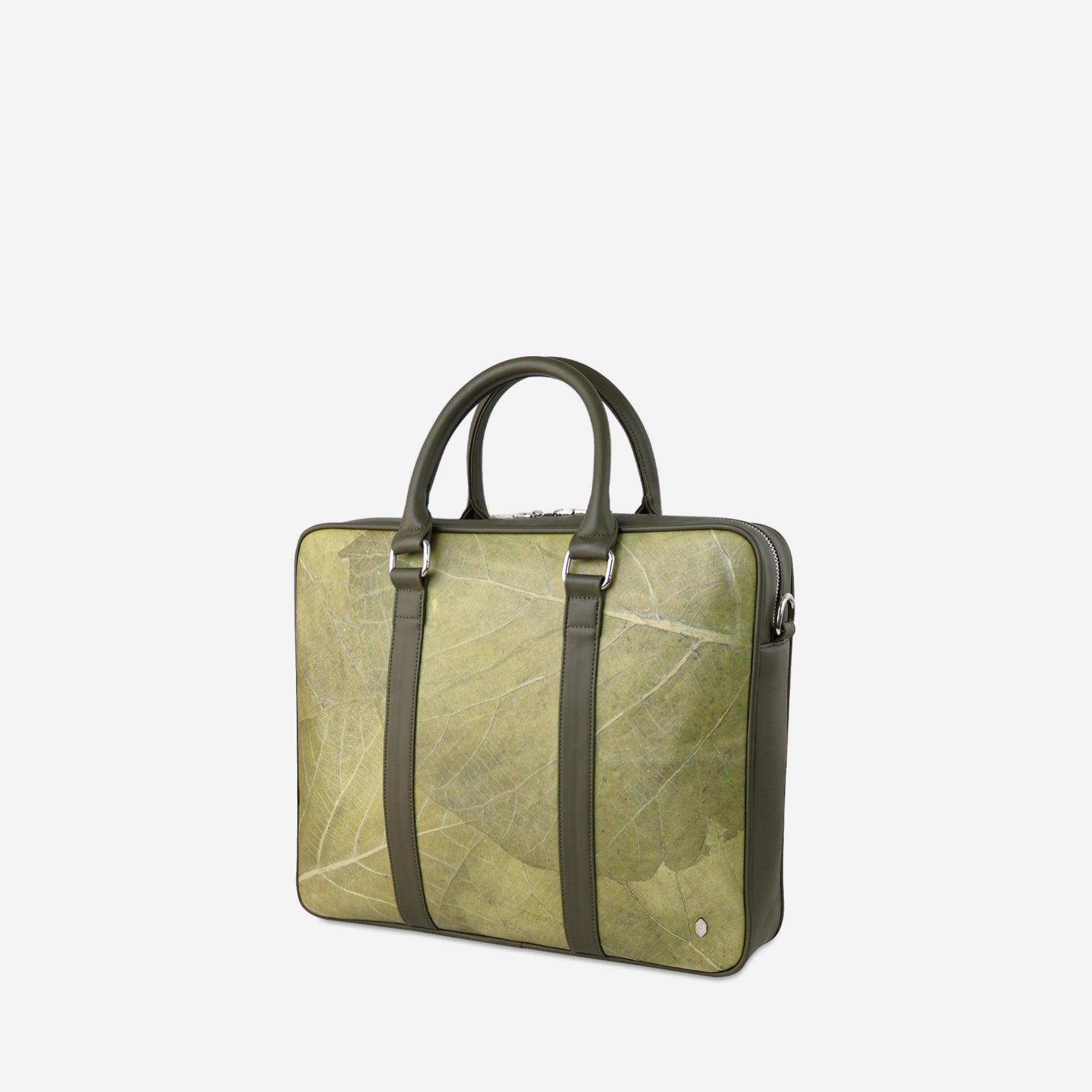 A side viewed of  the Cambridge briefcase made from olive leaf leather, showcasing its unique green leaf texture and eco-friendly design. The briefcase features a structured rectangular shape, rounded top handles, and a zip closure. It has an elegant and modern aesthetic suitable for professional use, with a design that emphasizes environmental consciousness.