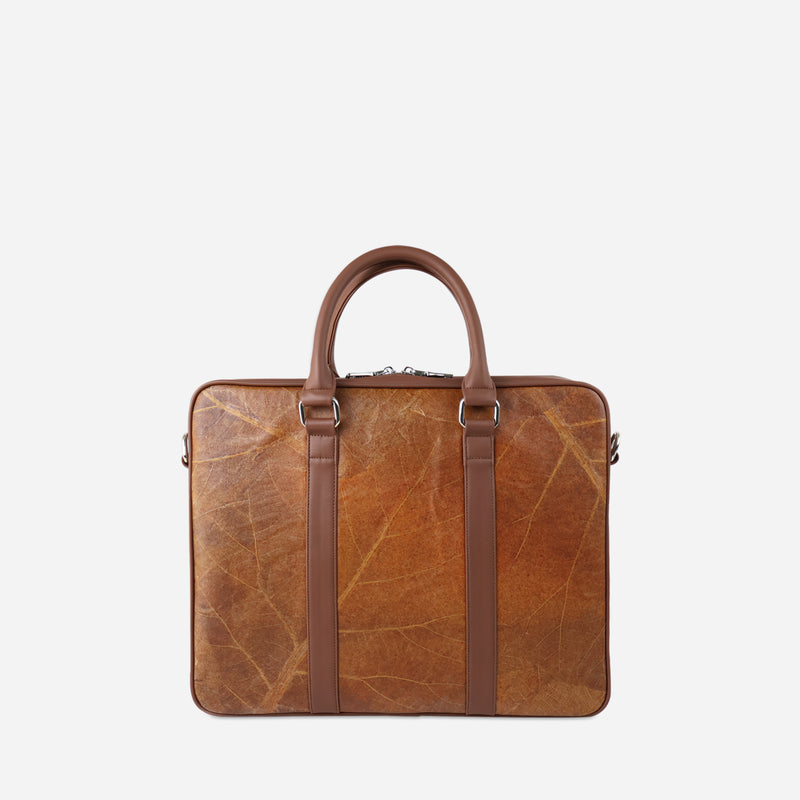 A back viewed of A Thamon spice brown leaf leather Cambridge briefcase displayed against a white backdrop, featuring a unique leaf vein texture, dual top handles, and side zipper.