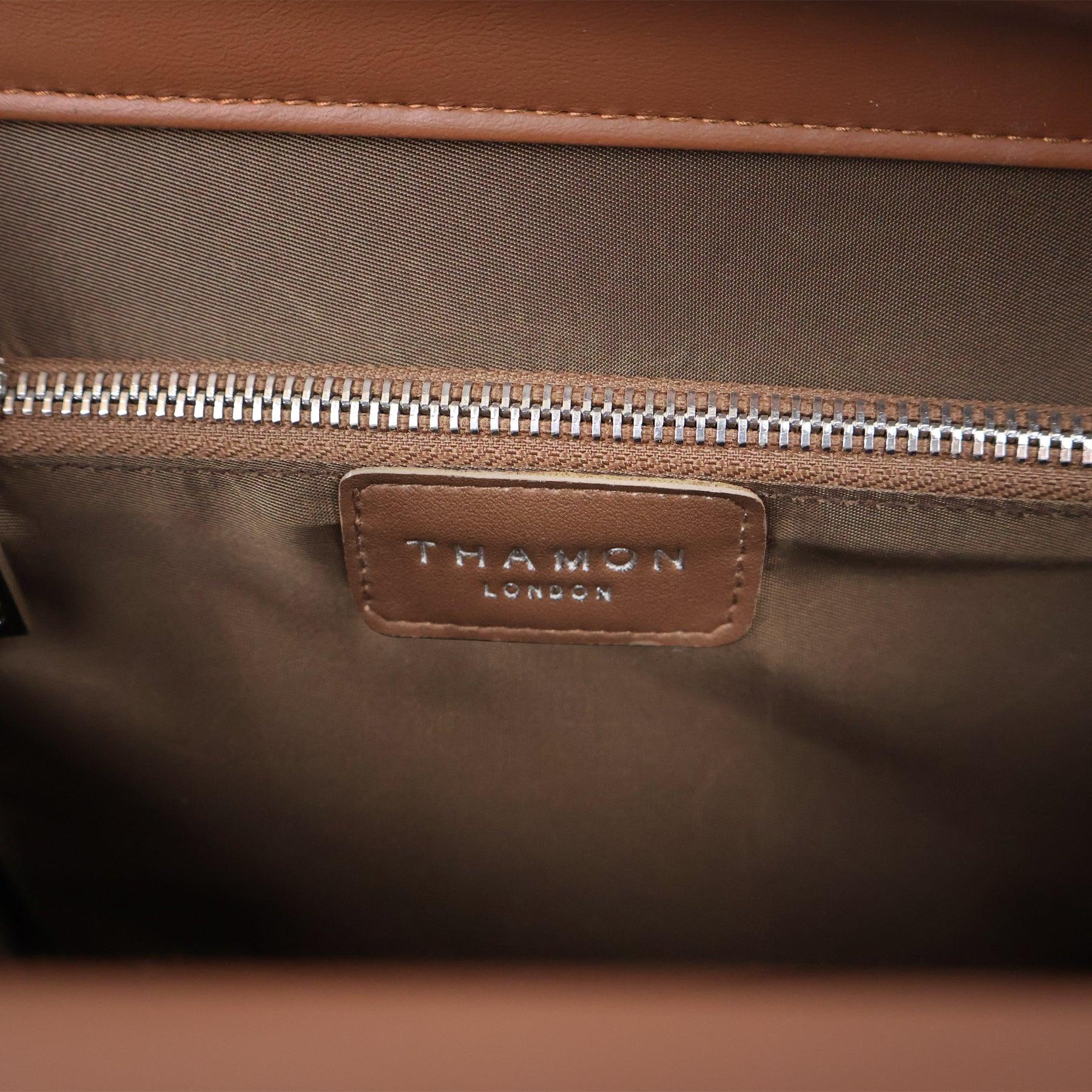 Interior view of the Walnut Brown Ingrid Bag by Thamon, showing inner zip pocket and branded lining