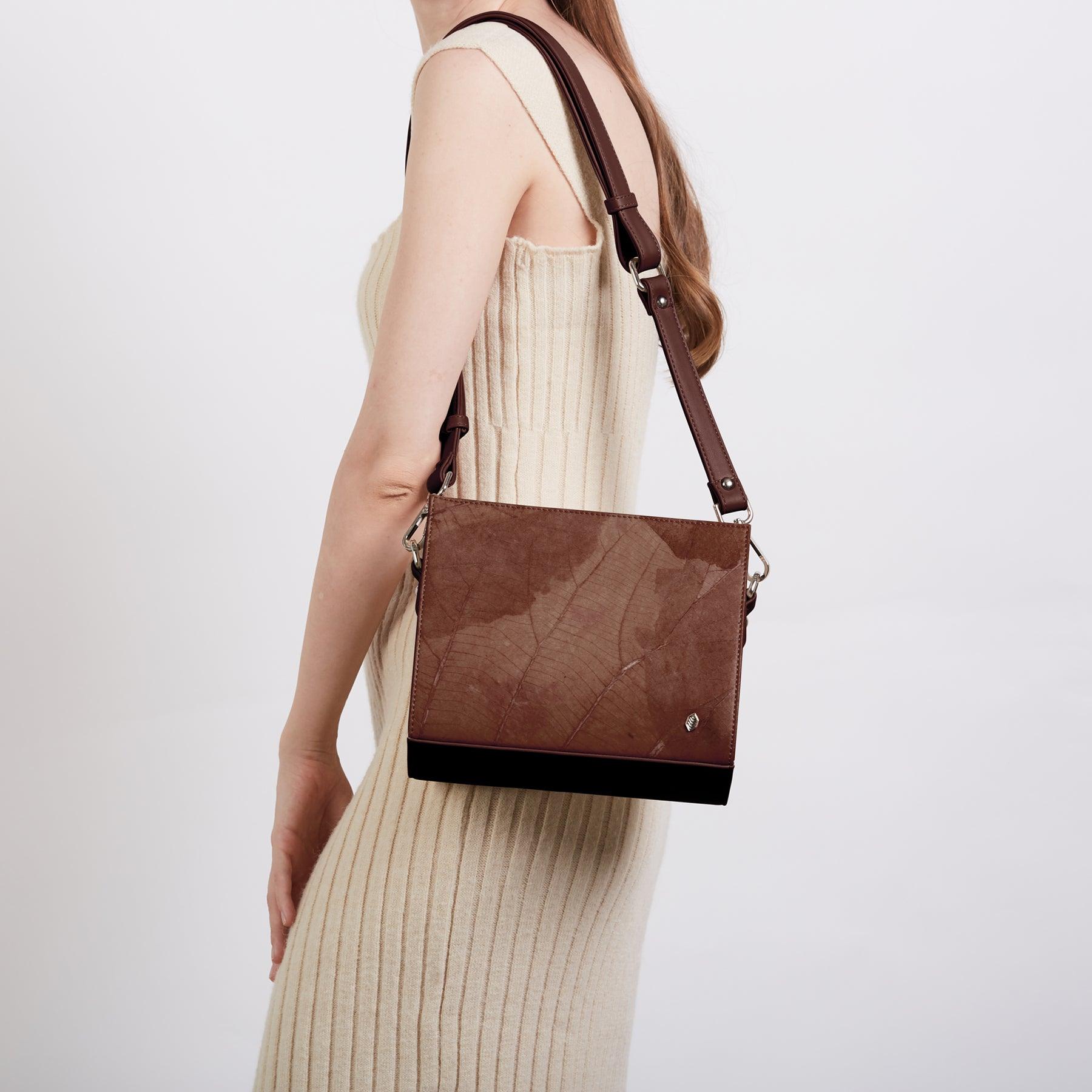 Model carrying the Walnut Brown Ingrid crossbody bag by Thamon, crafted from Leaftex (real leaf leather)